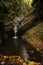 Small waterfall inside a narrow rocky canyon