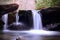 Small Waterfall with Moss Covered River Stones in the Bright Sun Light in the Smoky Mountains