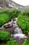 Small waterfall and mountain.