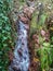 Small waterfall with reddish rocks