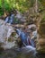 Small waterfall between rocks in autumn