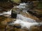 Small waterfall among stones in beautiful nature