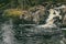 A small waterfall among the stones in the Karelian forest