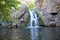 Small waterfall with swimming hole below