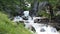 Small waterfalls of an alpine mountain stream with fresh and bubbling water