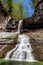 Small waterfalls cascade in the forest near Vladivostok, Russia