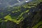 Small waterfalls on summer green hills in Alps Valley