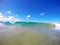 Small wave curling on a tropical beach