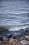 Small wave on the stone shore. Wild Nature Dramatic Background