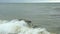 Small waves broken on coastal stones in Black sea near Odessa. Coastline, splashing, crashing, seafoam.