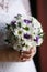 Small wedding bouquet in the hands of the bride