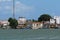 Small white and blue fishing boats and buildings from the river`s or ferry`s point of view. Location Brejo Grande, Brazil, South