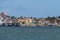 Small white and blue fishing boats and colorful buildings from the river`s or ferry`s point of view. Location Brejo Grande, Brazil