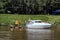 Small white and blue yacht on the river