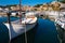 Small white boat anchored in the harbour.