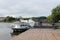 Small white boat stationed next to pier