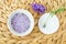 Small white bowl with purple lavender crystal bath salt foot soak. Homemade pedicure, spa and beauty treatment recipe