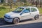 Small white car Opel Corsa left side and front view
