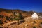 Small white church against the rough landscape of Naxos island