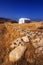 Small white church against the rough landscape of Naxos island