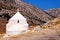 Small white church against the rough landscape of Naxos island