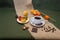 Small white cup with coffee, coffee beans on burlap green background