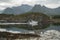 a small white fishing boat floats through the water along the rocks, norwegian seascape, rocky coast with dramatic skies