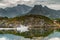 a small white fishing boat floats through the water along the rocks, norwegian seascape, rocky coast with dramatic skies