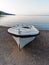 Small White Fishing Boat on Pebbly Beach, Greece