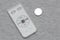 Small white and grey remote controller and a button cell coin lithium battery