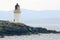 Small white lighthouse on Scottish island
