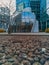 Small white modern building with glassy reflecting facade over a lot of small stones