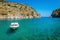 Small white motorboat anchored in sea bay