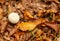 Small white mushroom Lycoperdon perlatum on ground covered with autumn leaves