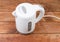 Small white plastic electric kettle on an old wooden table