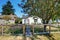 Small white rambler house with concrete walkway.