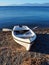 Small White Rowboat on Pebbly Bech