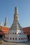 A small white tower that is located on the territory of the Temple of the Emerald Buddha. Religious architectural art of Southeast