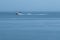 Small white yacht speeding away across the Kvarner gulf