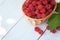 Small wicker basket with fresh ripe raspberries