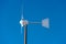 Small wind turbine on blue sky - Renewable energy