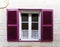 Small window with purple shutters