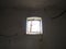A small window at the top of the wall. Scary walls with cobwebs. Old church dormer. Halloween or haunted place. Prison cell with