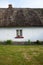 Small window on traditional irish thatched cottage