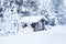 Small wooden blockhouse under snow