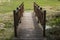 A small wooden bridge over a stream. Symmetrical photo