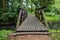 A small wooden bridge in the park. Crossing a small river in the forest area