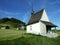 Small wooden chapel in the picturesque pastures