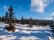 Small wooden cottage in the middle of winter forest