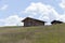 Small wooden farm house, cottage or log cabins on meadow on Alpe di Siusi, Seiser Alm, South Tyrol, Italy